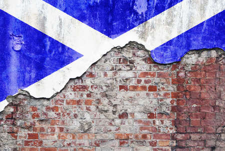 Scotland wall. Grungy old brick wall with Scottish flag on broken render surfaceの写真素材
