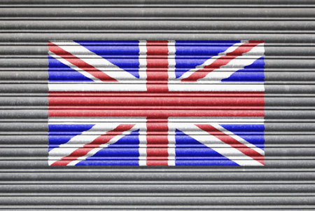 UK Metal Shutter. United Kingdom Union Jack flag on metal roller shutter doorの写真素材