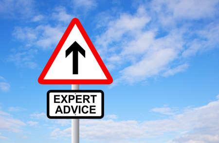 Expert advice arrow sign post against blue skyの写真素材