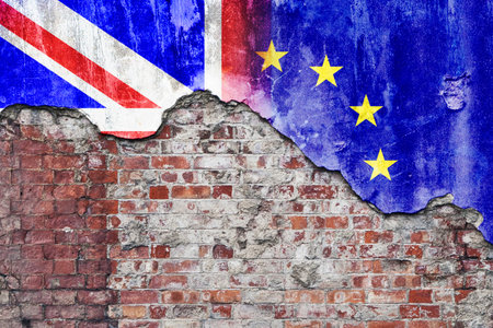 Grungy wall with painted UK and European Union flags flaking off