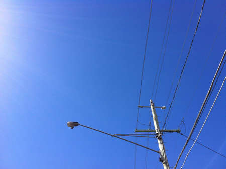 Wooden electricity and light pole with winter blue skyの素材