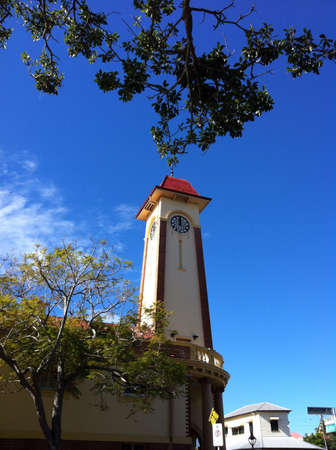 Tall clock tower in bright blue sky relaxing dayの素材