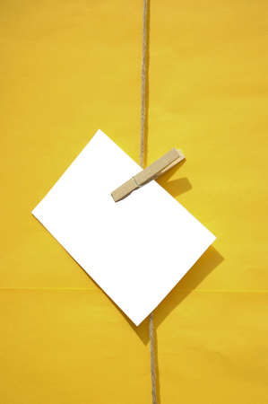 white blank reminder note on yellow backgroundの写真素材