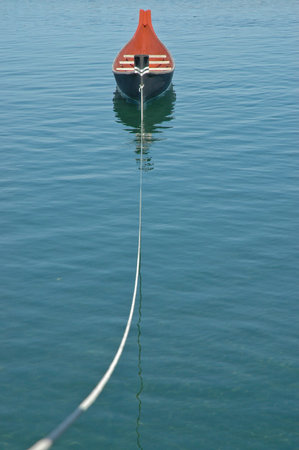rowing boat floats on calm lake