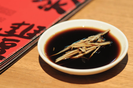 Black Chinese vinegar dipping sauce for Shanghai mini bunの写真素材
