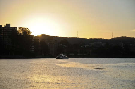 A ferry in Brisbane River at the sun set timeの写真素材