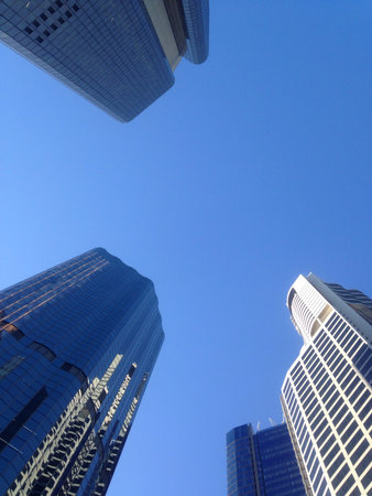 Look up to blue sky to see high rise financial buildingsの素材