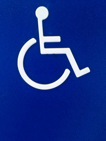 Disability person symbol on blue metal sheetの写真素材