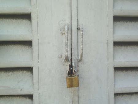 Vintage closed door with golden lockの写真素材