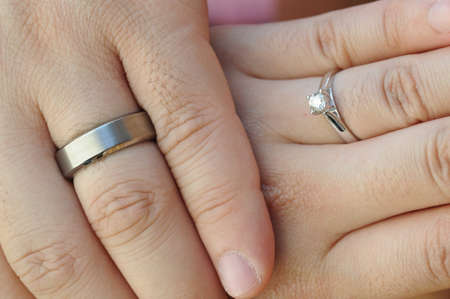 Wedding rings on fingersの写真素材