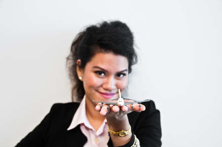 Business woman hold plane model toy on handの写真素材