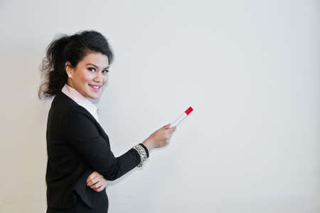 Business woman present with pen on white background and laughting.の写真素材