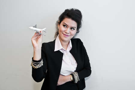 Business woman hold plane model toy on handの写真素材