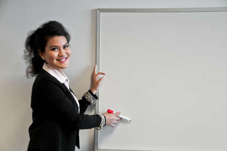 Business woman present with draw board on white background and laughting.の写真素材