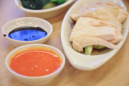 Delicious legendary Singaporean Hainanese chicken rice with two tones dipping sauce