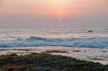 Evening sunset scene at Tanah Lot beach in Bali