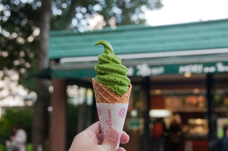 Left hand holding Green tea matcha flavour soft serve ice cream in Tokyoの写真素材
