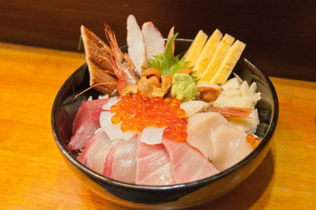 Full bowl of fresh Japanese seafood platter on riceの写真素材