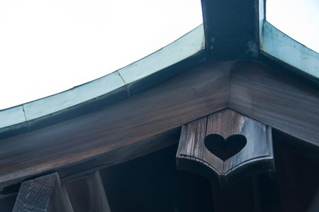 Wooden heart shape hole on a temple roofの写真素材