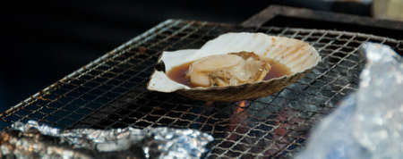 Grilled giant Hokkaido scallop on charcoal cook stoveの写真素材