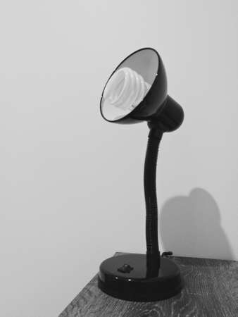 Classic generic light lamp on wooden table in black and whiteの写真素材