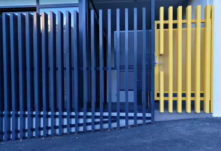 Modern blue and yellow metal fence of an apartmentの写真素材