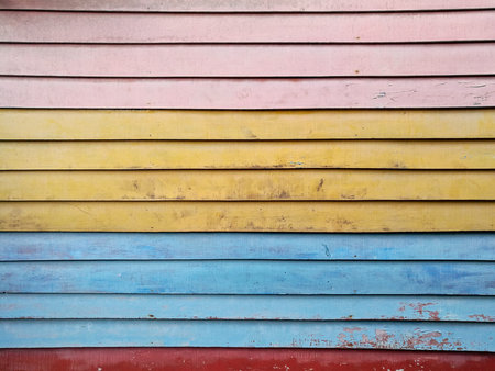 pink yellow blue red plank wooden board background wallの写真素材