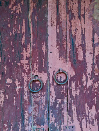 Old vintage rustic maroon wooden door closedの写真素材