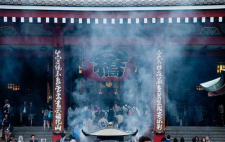 Smoke scene of Grand traditional big lantern of Sensoji temple in Tokyo. The text means the central gate of the temple.の写真素材