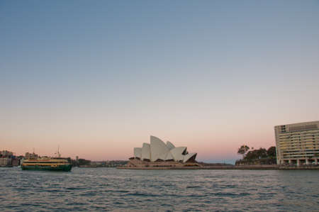 SYDNEY, AUSTRALIA - MAY 5, 2018: Sydney Opera House with famous Sydney city ferry in late afternoon and twililght sky.のeditorial素材