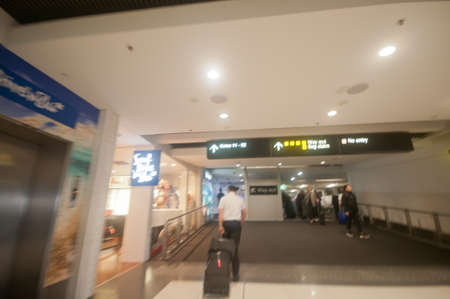 Blurry scene of rushing to follow a flight captain to pass the scanner gate in the airportの写真素材