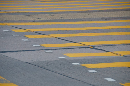 Abstract yellow painted traffic line pattern on concrete road street backgroundの写真素材
