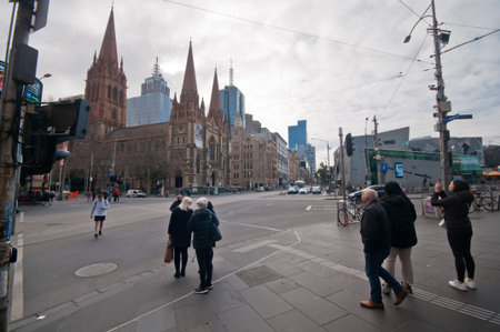MELBOURNE, AUSTRALIA - JULY 26, 2018: Crowd and intersection between St Paul Cathedral and Federation Square in Melbourne Australiaのeditorial素材