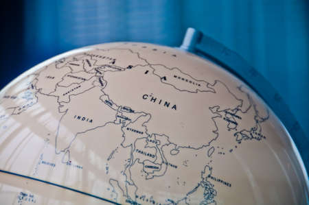China India and South East Asia countries map in a retro old classic vintage Earth globe in executive management board roomの写真素材