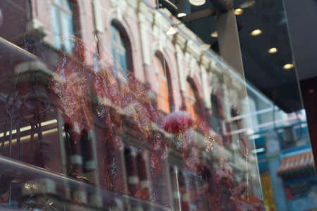 Roasted duck and BBQ pork hanged near Chinese restaurant window in Melbourne Australiaの写真素材