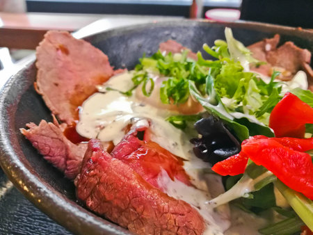 Premium Japanese beef Wagyu thin grilled and sliced topping with white Italian dressing sauce and...
