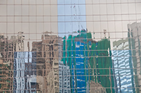 Reflection of high-rise skyscraper urban office buildings on golden glass golden wall