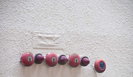 Many red fire alarm bells attached on a building wallの写真素材