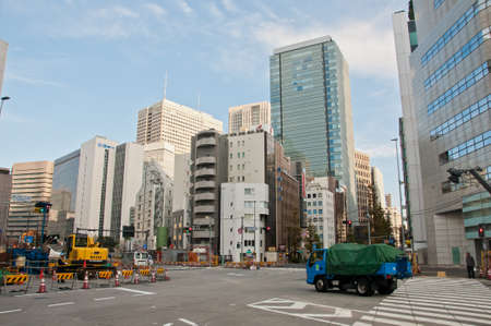 TOKYO, JAPAN - DECEMBER 1, 2018:  Japanese pedestrain stands to wait for traffic light before crossing the road near construction site in the morning.のeditorial素材