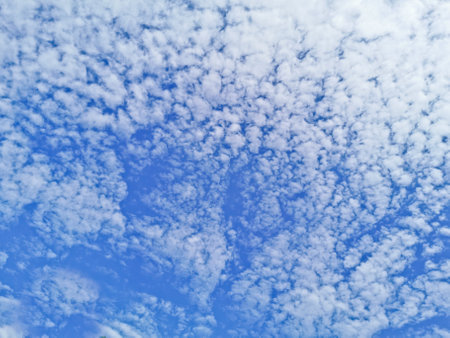 Cloudy blue sky look up to above in sunny dayの写真素材
