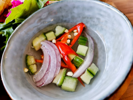 Cucumber onions spicy red chilli relish in clear white vinegar to eat with Satay curry
