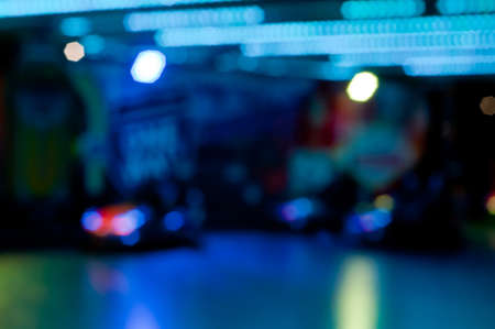 Abstract random colourful defocused blurred go-kart cars of fun fair background patternの写真素材