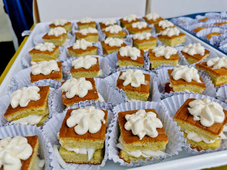 Simple chiffon vanilla cakes with white sweet topping on top in a seminar conferenceの写真素材