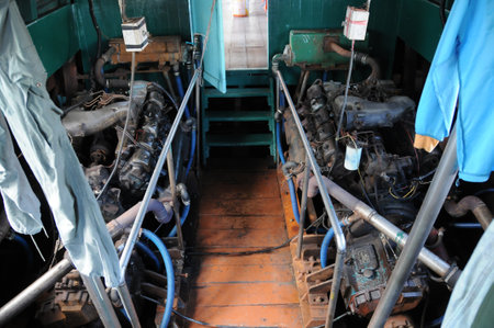 Dual old powerful engines of wooden ship sailing in the ocean. A lady is sitting in the passenger area.の写真素材