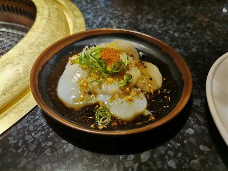 Japanese fresh Hokkaido scallops salad with sesame and garlic salty black sauceの写真素材