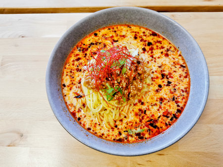 spaghetti with minced pork and spicy sauce in bowl on wood tableの写真素材