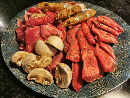 Platter of Japanese Yakiniku meat set consists of Wagyu mabled meat, mushrooms, tiger prawns beef tonguesの写真素材