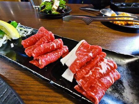 Raw Kobe Wagyu premium Japanese organic beef to be grilled in hot BBQ cookingの写真素材