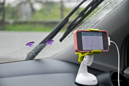 GPS software on a phone above driver console in rainy day drivingの写真素材