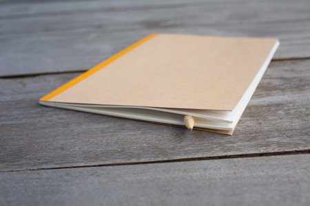 one pencil with recycle notebook on woodの写真素材